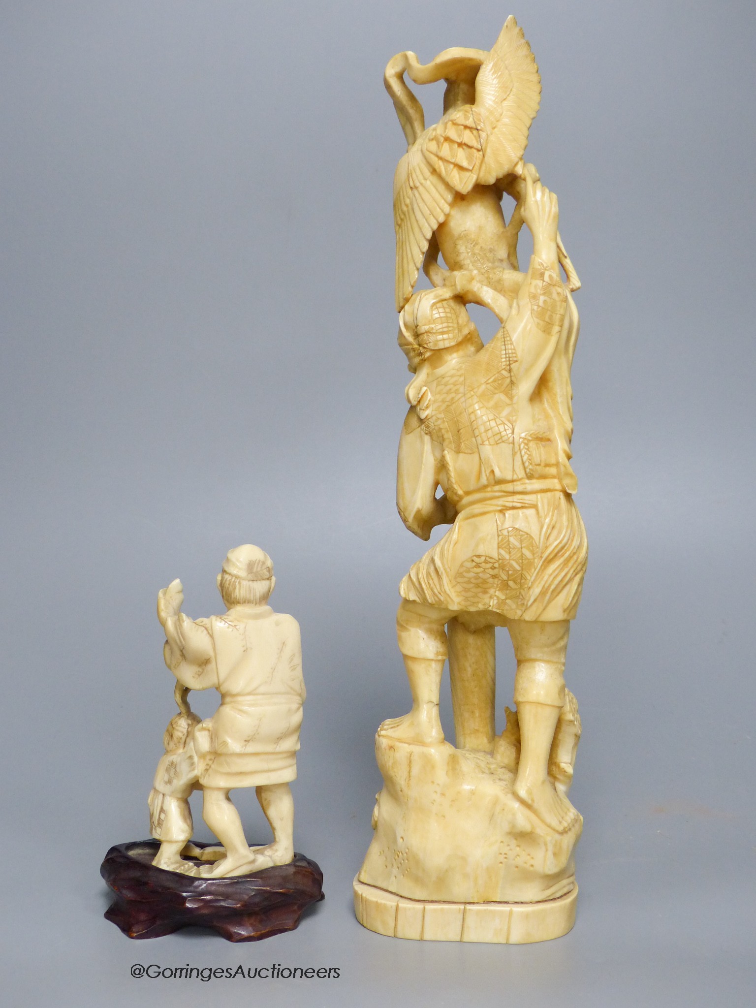 Two early 20th century Japanese walrus ivory okimono, tallest 29cm